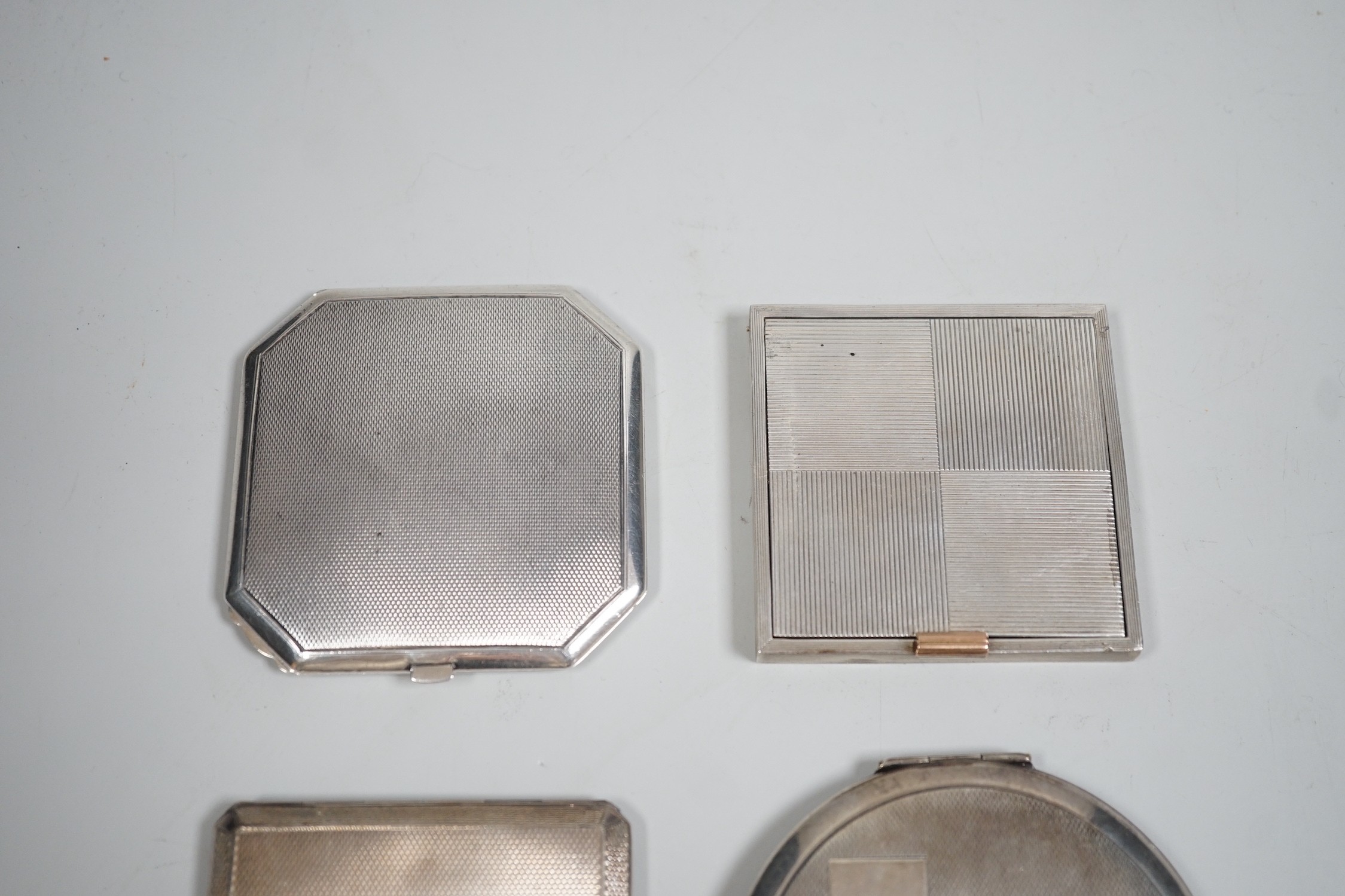 A George V Art Deco silver cigarette case, David Sutton & Sons, London, 1935, 65mm, with leather carrying case, together with three engine turned silver compacts.